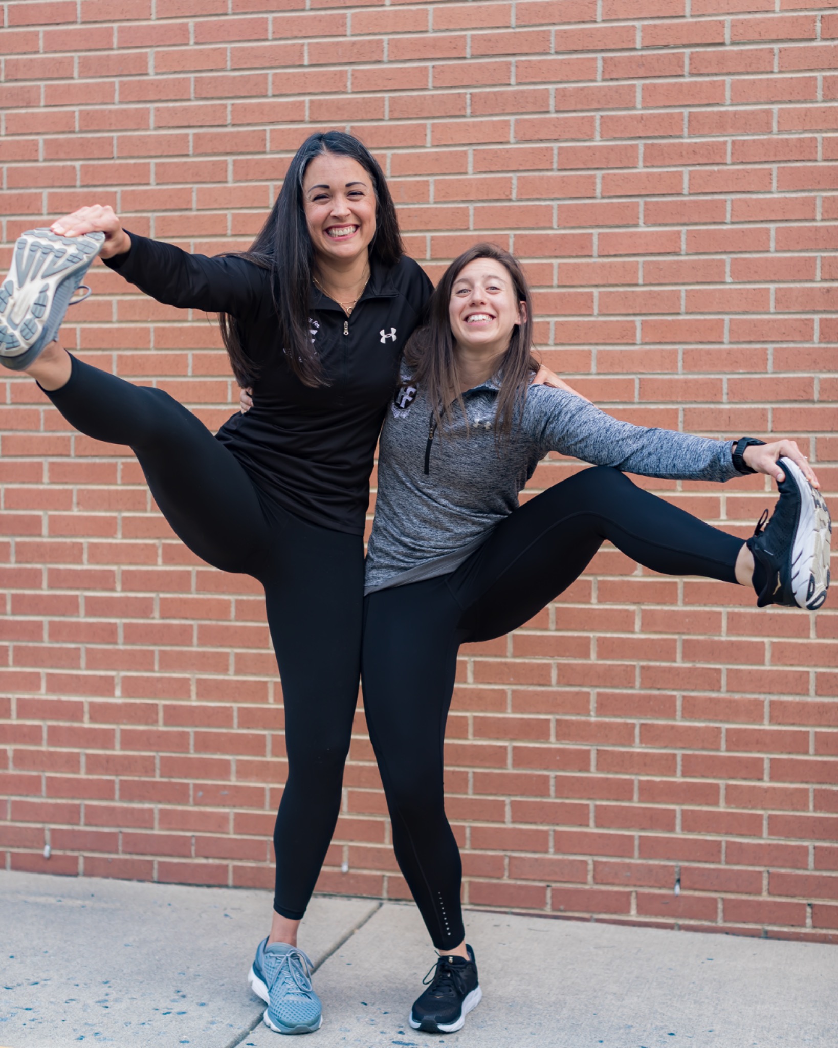 Fredericksburg Fitness Studio team members smiling and stretching together